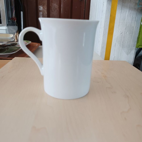Ceramic white cylindrical mug used