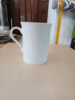 Ceramic white cylindrical mug used