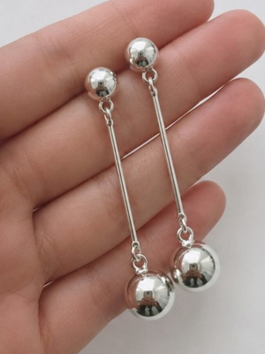 Long geometric drop earrings with silver spheres