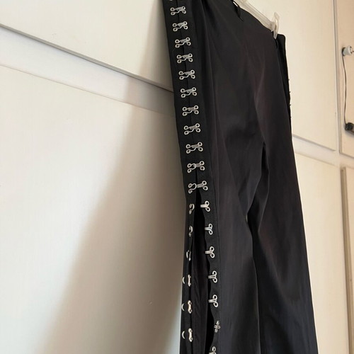 New shiny black pants with a design on the side