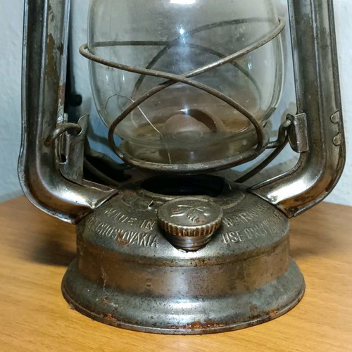 Vintage storm lantern used with cracked glass