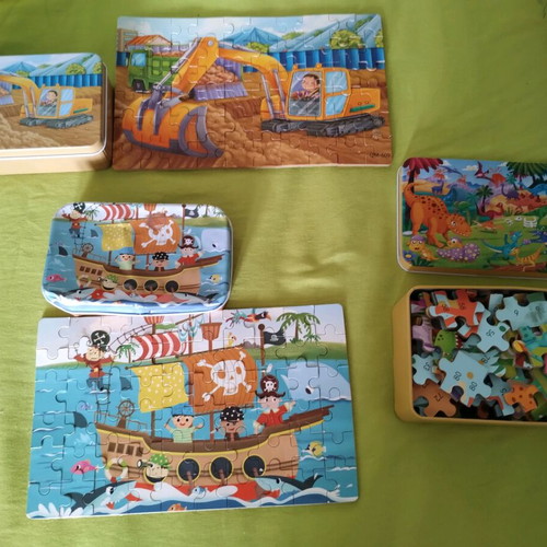 Puzzles in metal boxes like new, 3 pieces with dinosaurs, excavator and pirates
