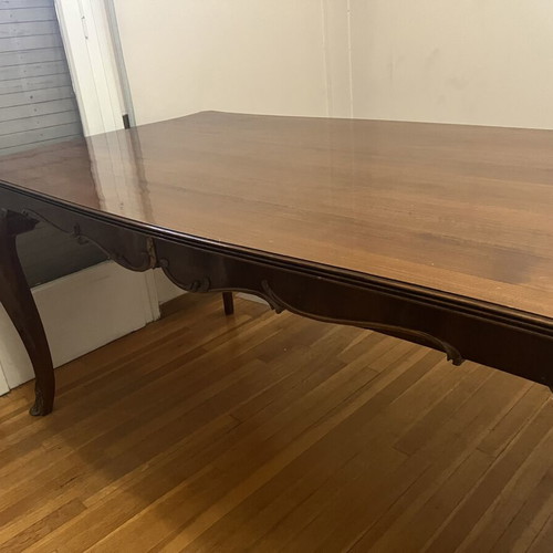 Wooden dining table used with carved legs and metal details