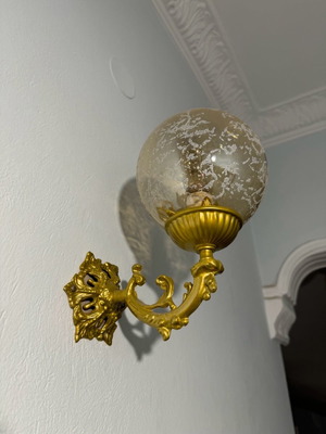 Brass wall sconce with glass globe like new