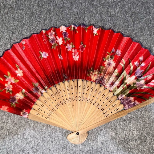 Wooden fan used, red with sakura blossoms