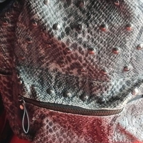 Snakeprint backpack used, grey with snake pattern and studs