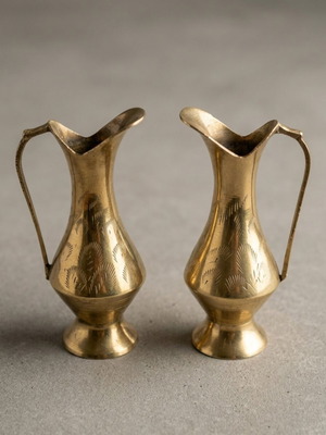 Brass pitchers set like new with carved designs and natural patina