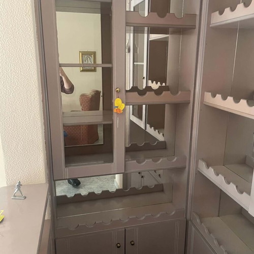 Mini bar like new with mirrors, cabinets, and carpeted floor