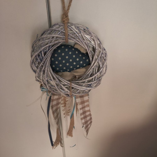 Handmade fabric fish decoration on white rattan wreath
