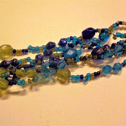 Bracelet with clasp and six rows of blue, light blue, and green beads