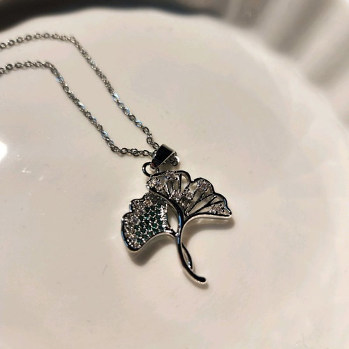 Silver necklace like new with tree design and green stones