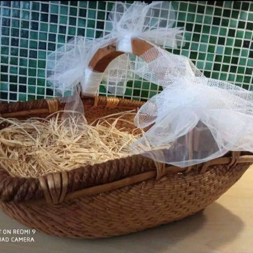 Wicker basket used with wooden handle and tulle decoration