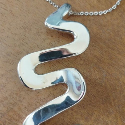 Silver necklace with wave-shaped snake pendant like new