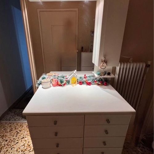 White furniture used with mirror and drawers