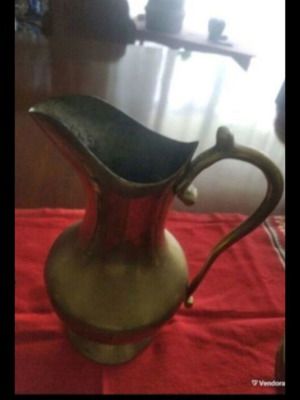 Antique brass pitcher with S-shaped handle used