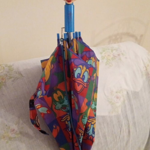 Disney umbrella used with blue Mickey Mouse handle, multicolored