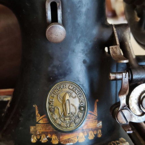 Singer sewing machine used with original wooden cover and key