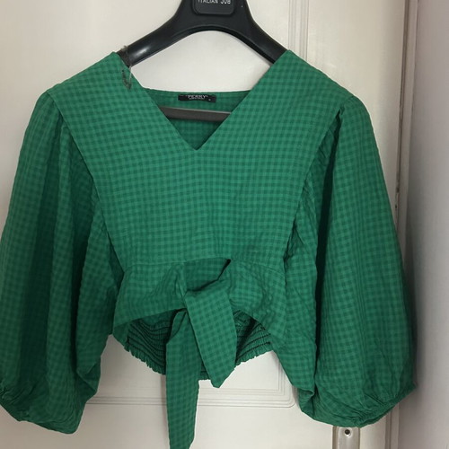 Emerald green two-piece set with cropped blouse and wide-leg pants