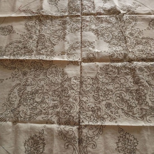 Stamped rosette with embroidered golden root on canvas