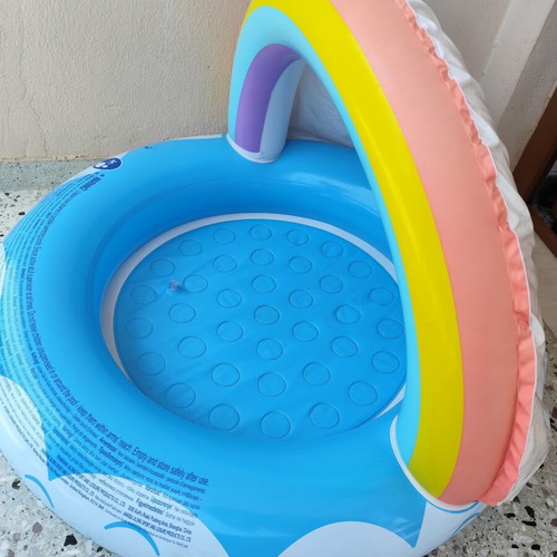 Blue children's pool with canopy used, rainbow design