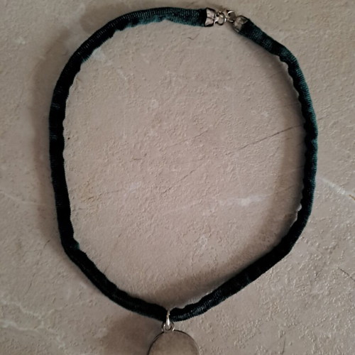 Pendant with stainless steel motif and velvet cypress strap like new