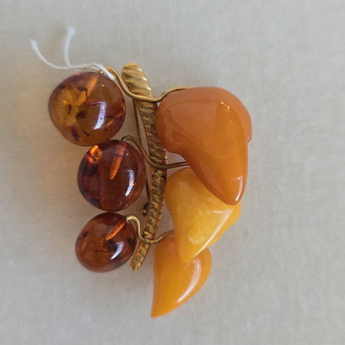 Baltic amber brooch with grape cluster design