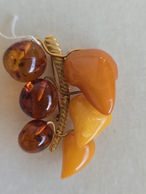 Baltic amber brooch with grape cluster design