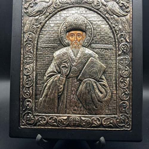 Silver embossed icon of Saint Nicholas used, with wooden base