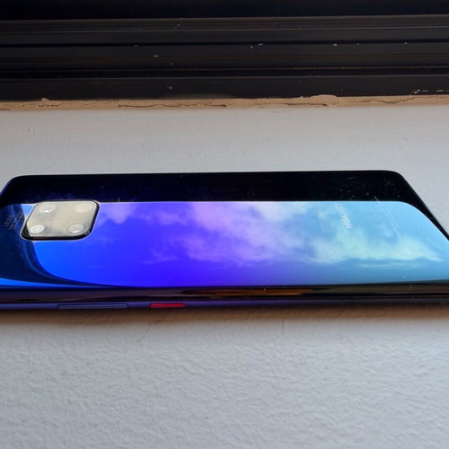 Huawei Mate 20 Pro smartphone with charging cable, cracked screen