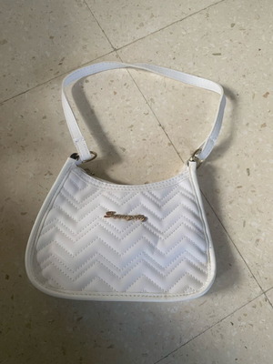 White quilted purse with gold hardware and extra long strap