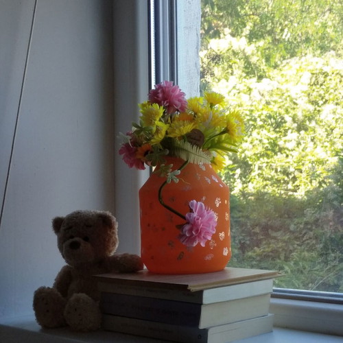 Handmade translucent orange vase with silver flowers
