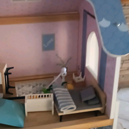 Wooden dollhouse used with extra accessories pack