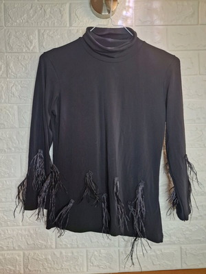 Turtleneck blouse with feathers like new