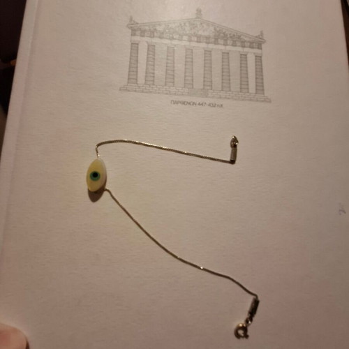 Thin bracelet with metal chain and eye centerpiece like new