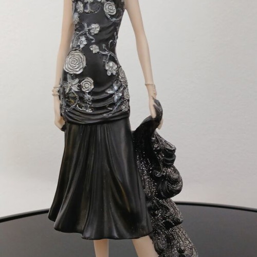 Decorative figurine of a girl with rose dress