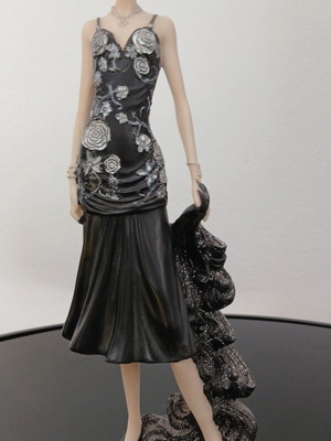 Decorative figurine of a girl with rose dress