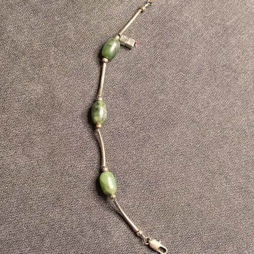 Minimal bracelet with green stones and silver details like new