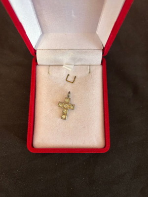 Silver cross used with white stones