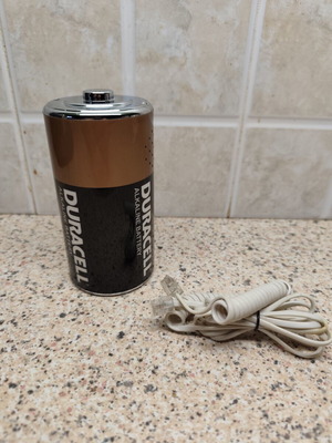 Vintage telephone shaped like a battery, like new