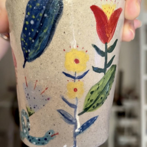 Illustrative ceramic mug handmade with floral design