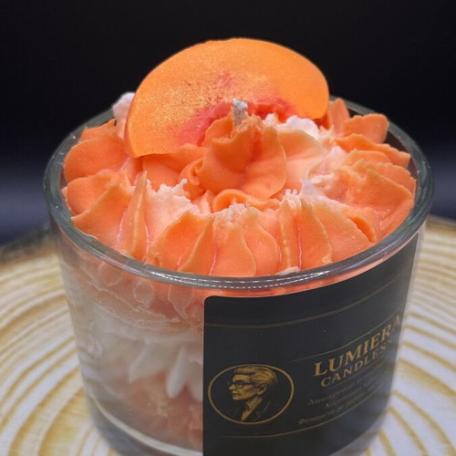 Handmade soy candle in glass container with peach scent