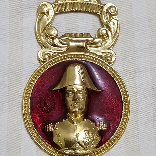 Collectible metal bottle opener with Napoleon bust and red enamel