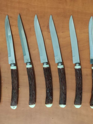 Vintage steak knives set of 9 with faux antler handles like new