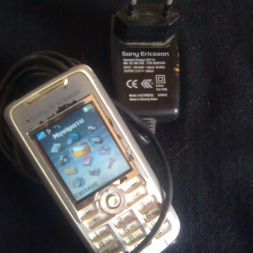 Sony Ericsson K700i used mobile phone with charger and headphones