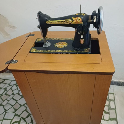 Singer sewing machine with cabinet used, motor and pedal included