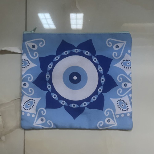 Blue fabric toiletry bag with eye design, 25 x 21 cm