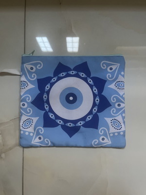 Blue fabric toiletry bag with eye design, 25 x 21 cm
