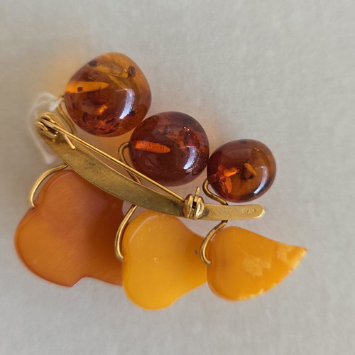 Baltic amber brooch with grape cluster design