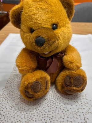 Plush teddy bear like new with bow and hanging cord