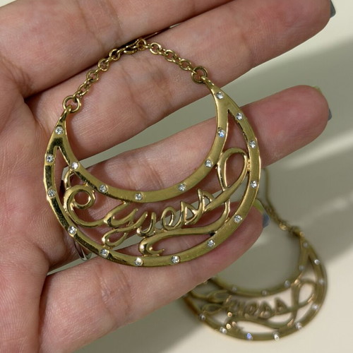 Guess goldtone dangling earrings with rhinestones